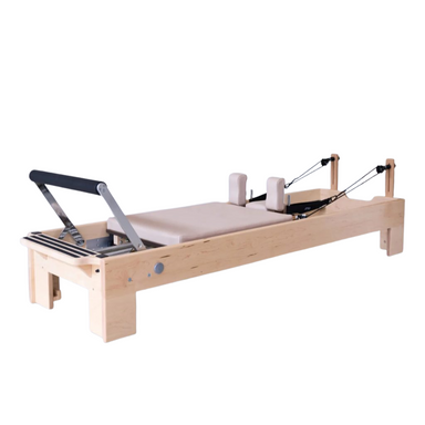 Atro Pilates maple wood reformer with antibacterial upholstery and adjustable resistance springs for smooth, silent workouts