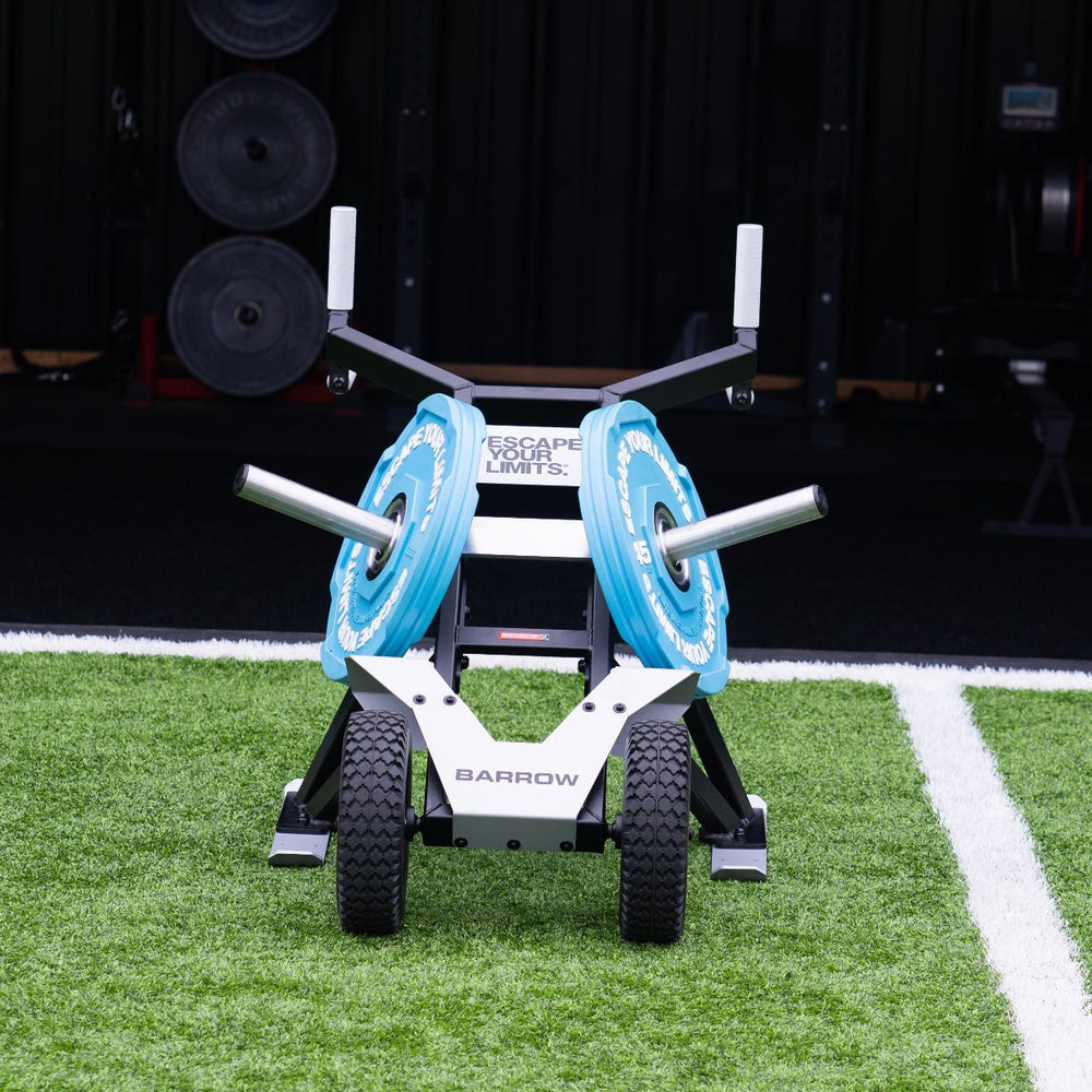 Escape Fitness Barrow Sled black loaded carry and sled push fitness equipment with blue weight plates on gym turf