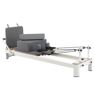 Aluminium Pilates reformer with grey padded carriage and adjustable resistance springs for home and studio use