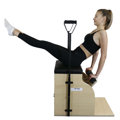 Woman exercising on Atro Pilates Chair with dual handles and anti-bacterial leather seat