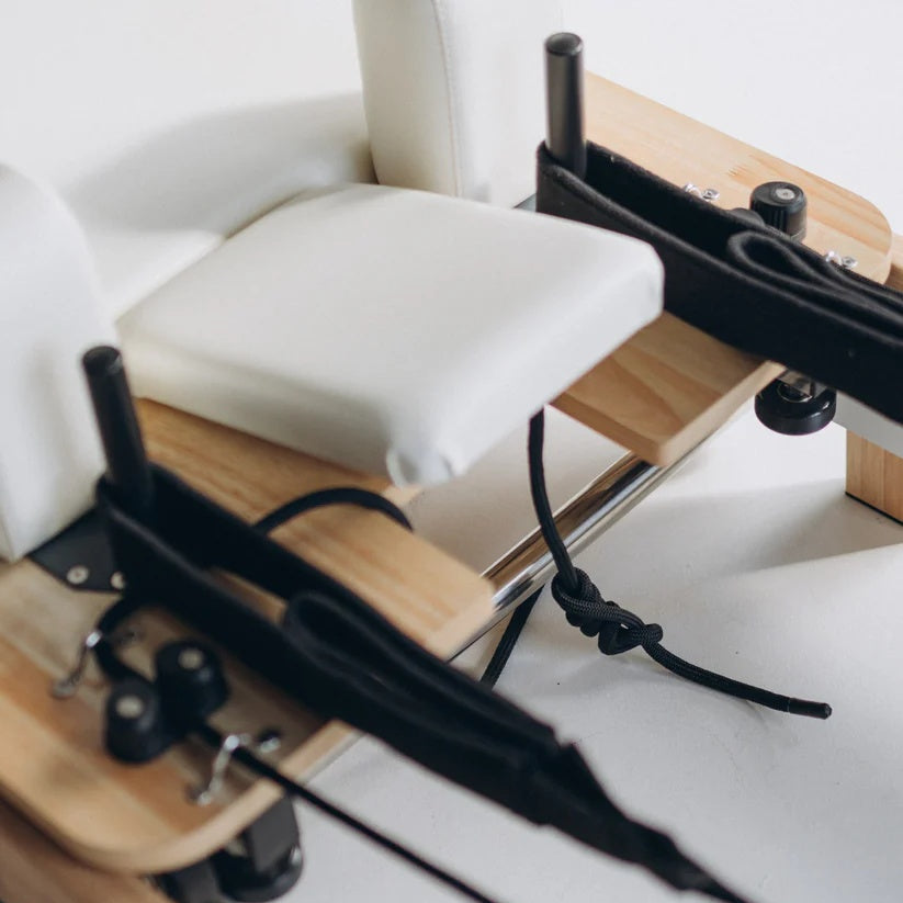 Heavy-duty spring system on foldable Pilates reformer for custom resistance training